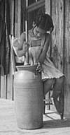 young girl butter churn
