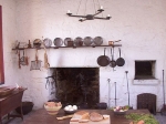 kitchen fireplace with hanging gridirons, skillets etc.