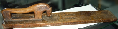 board with carved decoration and horse-shaped handle