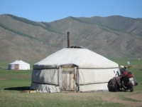 Round white tent with chimney in sloping roof